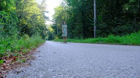 Woman Walking Empty Asphalt Road Through Countryside Stock Footage 345830260