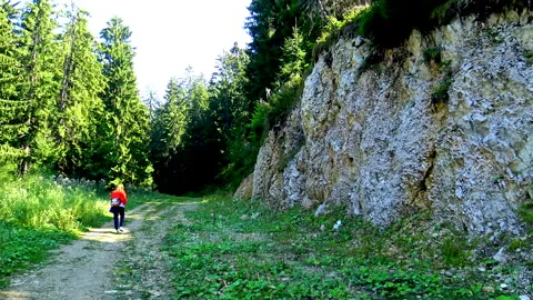 A woman walking at empty mountain path 動画素材 145768997