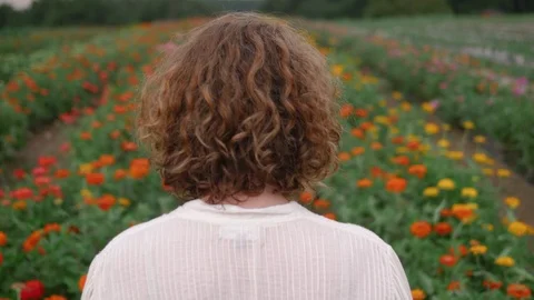 Woman Walking in Flower Patch Stock Footage 85572489