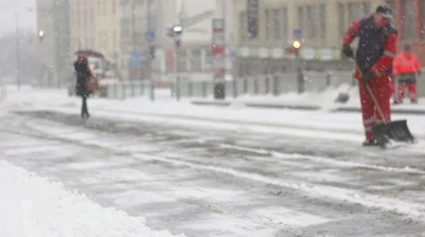 Woman walking on frozen pavement during snow storm Stock Footage 59641274