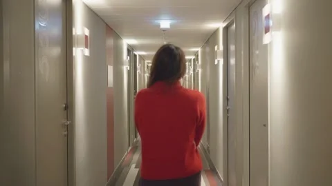 Woman Walking in Hotel Corridor Stock Footage 329375053