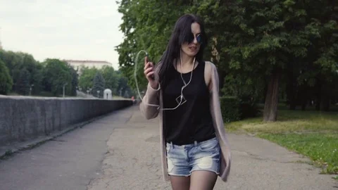Woman is walking in the park and dancing Stock Footage