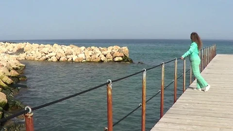 Woman walking on pier Stock Footage 72280098