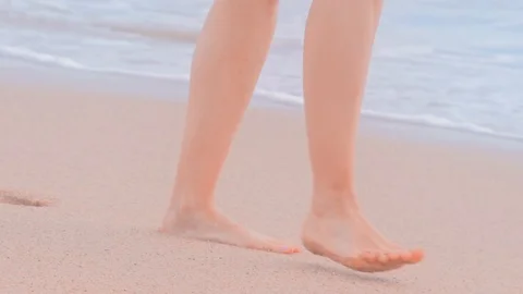 Woman walking on sand beach. Closeup of female feet Stock Footage 127106341