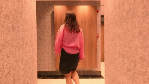 Woman walking through elevator corridor indoors, modern travel Vídeos de archivo 327830449