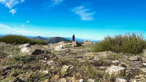Woman walking on top of a mountain Stock Footage 252191316