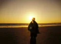 Woman walking towards sunset beach in slow motion Loop Footage