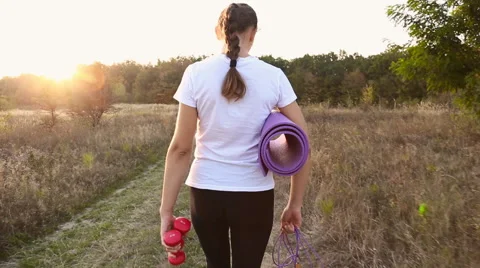 Woman walking with a workout Stock Footage 68487580