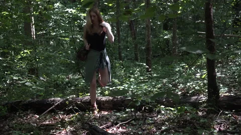 Woman walks over log while hiking in forest (Part of a sequence) Stock-Footage 137127345