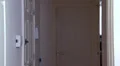 Woman walks through front door talking on phone HD Footage