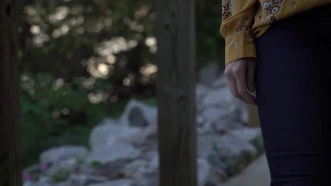Woman walks under covered path hand only Stock Footage 83752392