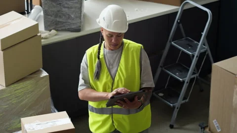Woman Warehouse Worker Checking Inventory on Digital Tablet Stock Footage 337307512