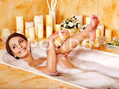 Woman wash leg in bathtube. Stock Photos