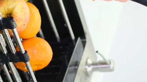 A woman washes an apple over the kitchen sink while preparing a fresh fruit Video stock 250354583