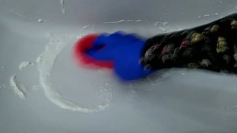A woman washes the sink using baking soda and vinegar Stock Footage 236558632