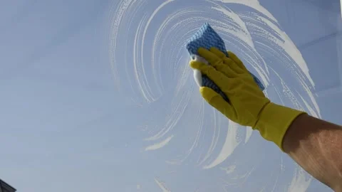 A woman washes a window. Video stock 286736346