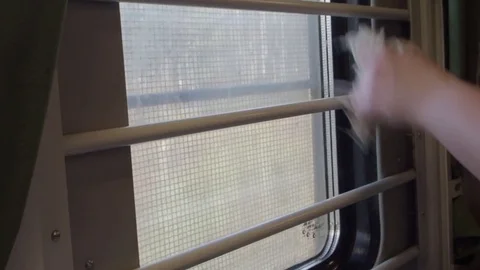 The woman washes a window in the train Stock Footage 75603738