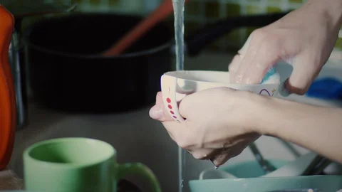 https://images.pond5.com/woman-washing-dishes-sponge-footage-118371949_iconl.jpeg