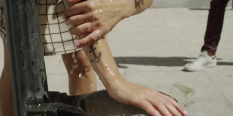 Woman washing her hands under a tap Stock Footage