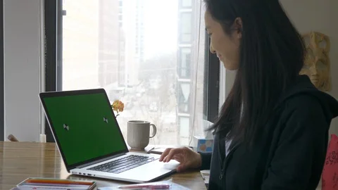Woman watching computer screen with chroma at home Stock Footage 128464617