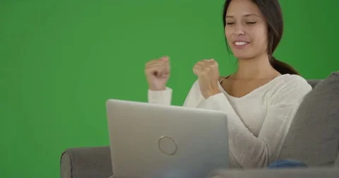 Woman watching her team losing the game on her computer on green screen Stock Footage