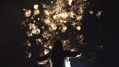 Woman watching holiday fireworks Stock Footage