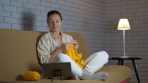 Woman watching an online knitting tutorial Video stock 344315396