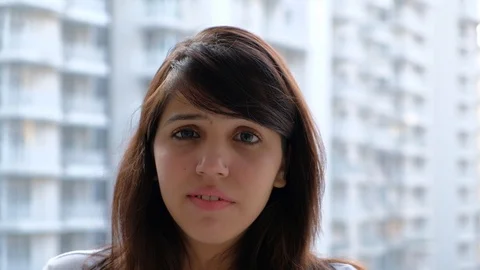  Woman watching something off camera that makes her scared and frightened and di Stock Footage 100618353