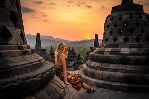 Woman watching sunset at borobudur indonesia Stock Photos