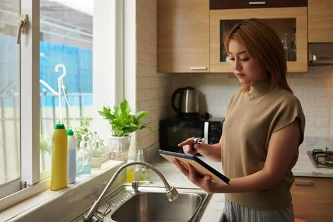 Woman Watching Tutorial and Fixing Leaking Tap Stock Photos