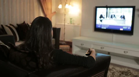 Woman Watching TV - Sitting On Sofa Stock Footage