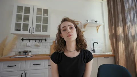 Woman waves hello to camera talking to friends on video call Stock Footage 201186506