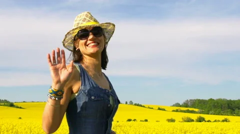 Woman waving to the camera while walking, steadycam shot, slow motion shot at 24 Stock-Footage 66546761