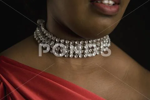 A woman wearing a diamond necklace Stock Photos