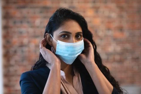 Woman wearing face mask at office Stock Photos