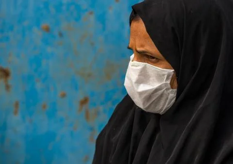 A woman wearing a face mask to protect from h1n1 influenza in panjshambe bazar, Stock Photos