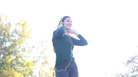 Woman wearing headphones and dancing, sending kiss to camera Stock Footage 59556003