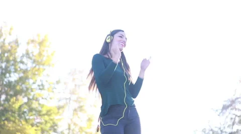 Woman wearing headphones and dancing, sending kiss to camera Stock Footage 59556007