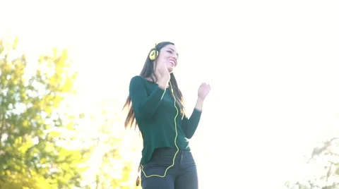 Woman wearing headphones and dancing, sending kiss to camera Stock Footage 59556008