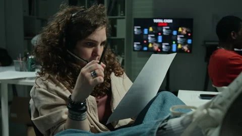 Woman Wearing Headset Reading Script in Scam Call Center 스톡 동영상 346709604