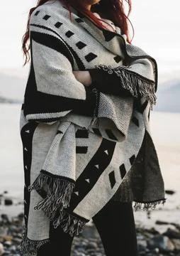 Woman wearing patterned wool blanket outdoors Stock Photos