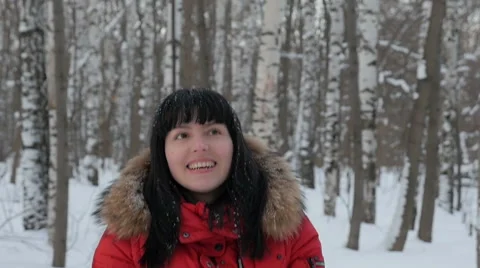 Woman wearing a red jacket throwing snow in the air in winter holidays Stock Footage 61892767