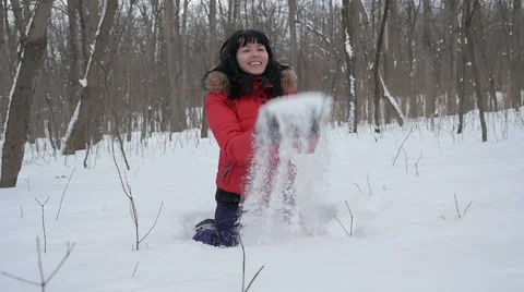 Woman wearing a red jacket throwing snow in the air in winter holidays Video stock 61893412