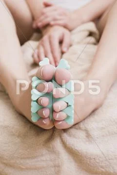 Woman wearing toe spreader, close-up Stock Photos