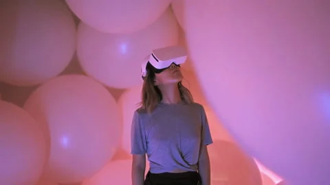 Woman wearing virtual or augmented reality headset surrounded cyberspace world Stock Footage 208859985