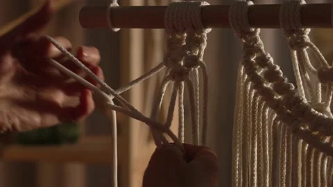Woman weaves pattern of macrame threads with her own hands for decoration or Stock Footage 172238262