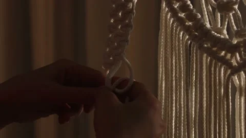 Woman weaves pattern of macrame threads with her own hands for decoration or Stock Footage 172238509