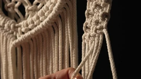 Woman weaves pattern of macrame threads with her own hands for decoration or Stock Footage 172240119