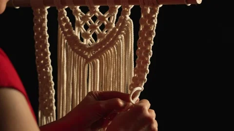 Woman weaves pattern of macrame threads with her own hands for decoration or Stock Footage 172240697
