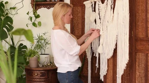 Woman weaving macrame from light threads in a home workshop. Stock Footage 154095850